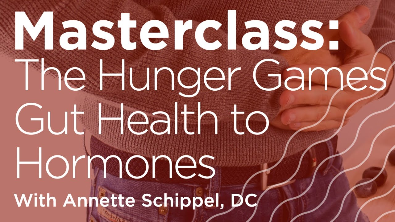 Hands clasp a stomach, suggesting discomfort. Text reads: "Masterclass: The Hunger Games Gut Health to Hormones With Annette Schippel, DC." Background features a person in casual clothes.