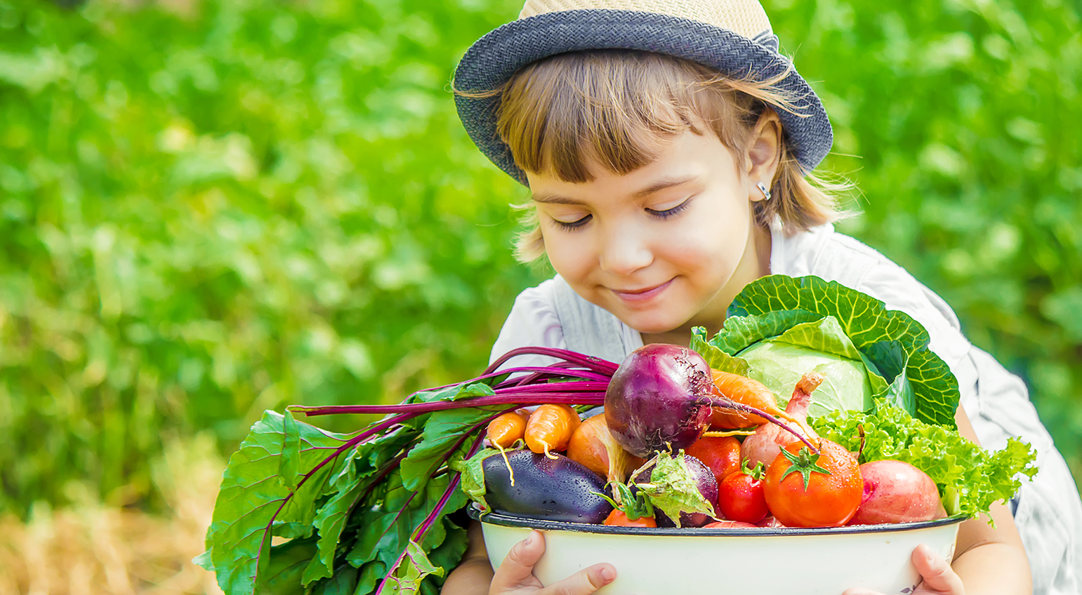 child holding vegetables from the garden which are good for gut health in kids
