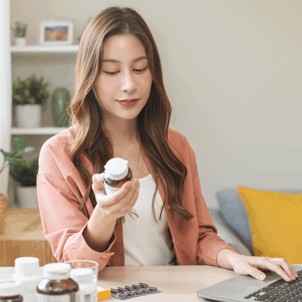 woman looking at a supplement bottle ingredient label