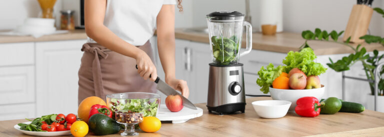 woman making a green smoothie