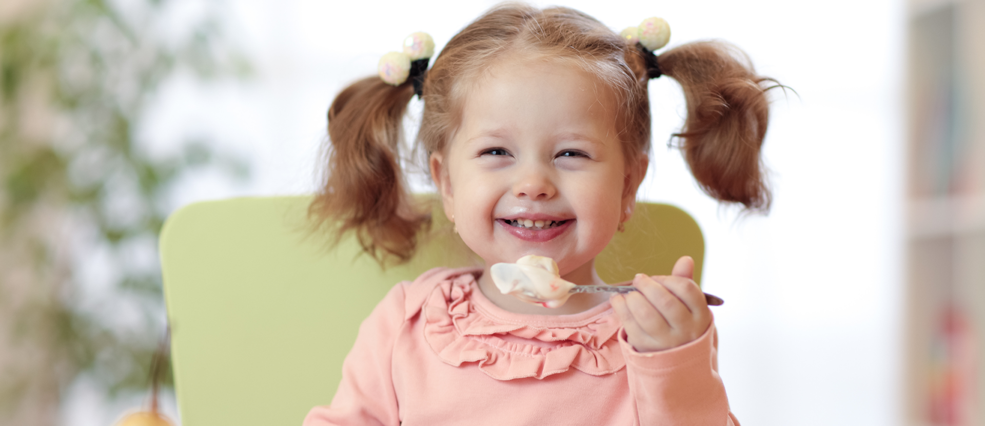 girl eating yogurt and fruit