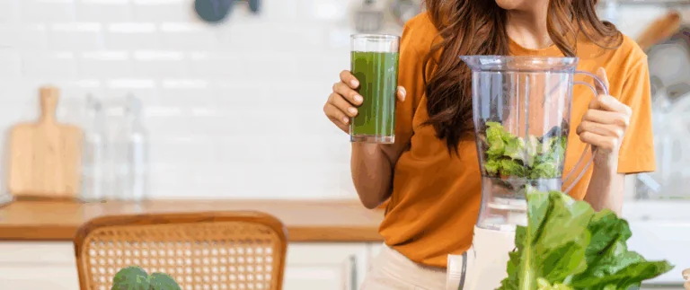 woman drinking green juice
