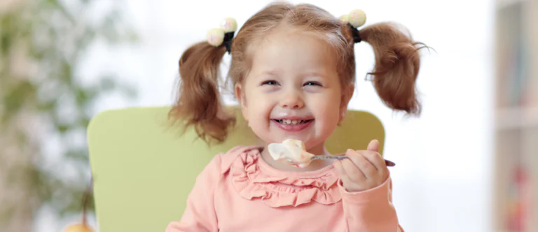 girl eating yogurt and fruit