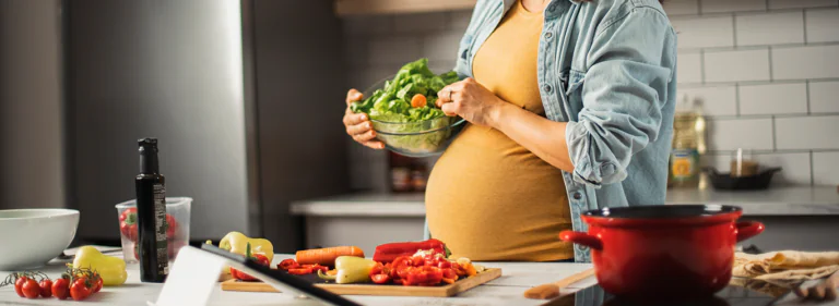pregnant woman making a salad
